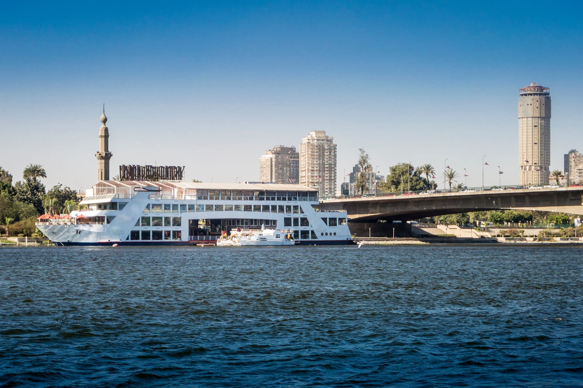 Pleasure ship on the River Nile with tower blocks in the background